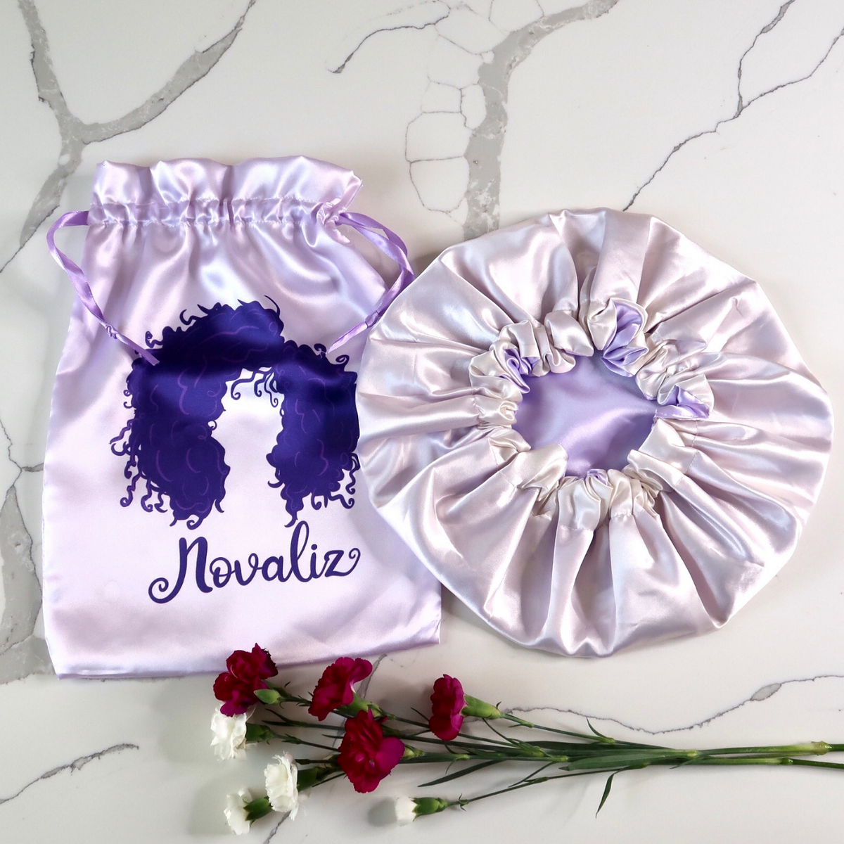 lilac silky satin bonnet with matching satin bag with dark pink logo of curly girl