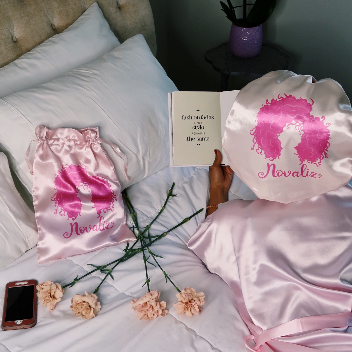 baby pink silky satin bonnet with matching satin bag with dark pink logo of curly girl